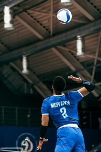 volleyball-player-serving-in-indoor-arena-mhnsls3gmlm